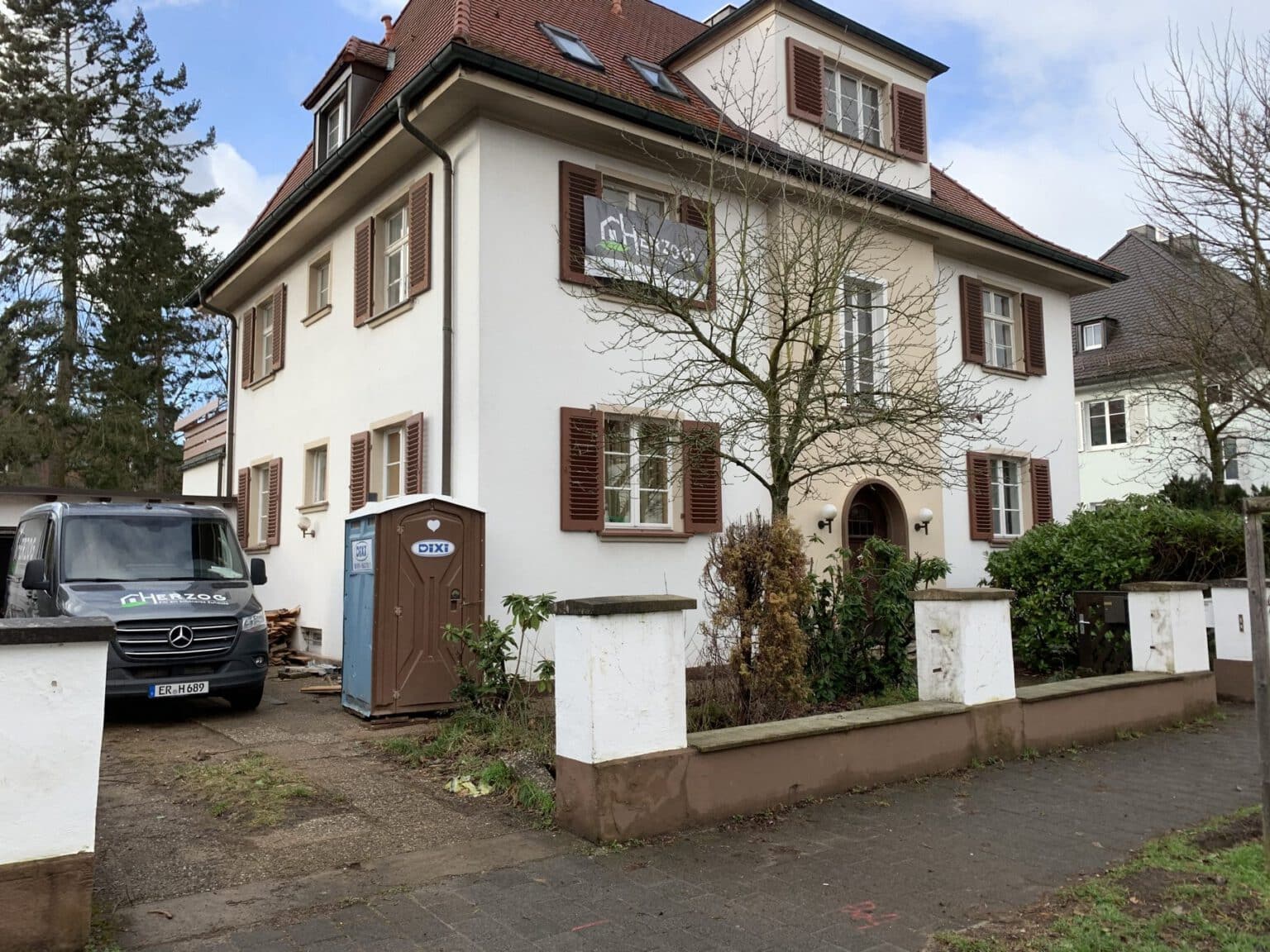 Mehrfamilienhaus in Erlangen, Baustelle mit HERZOG-Fahrzeug und Dixi-Klo